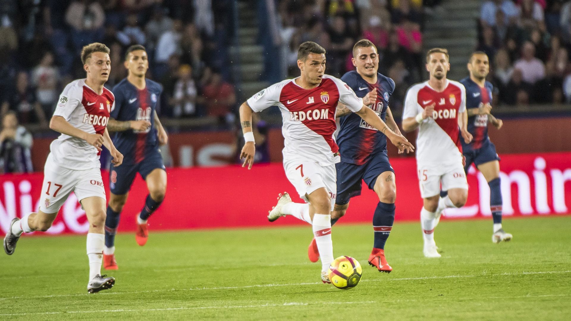 Monaco and PSG players tussle for the ball in midfield during their Ligue 1 clash.