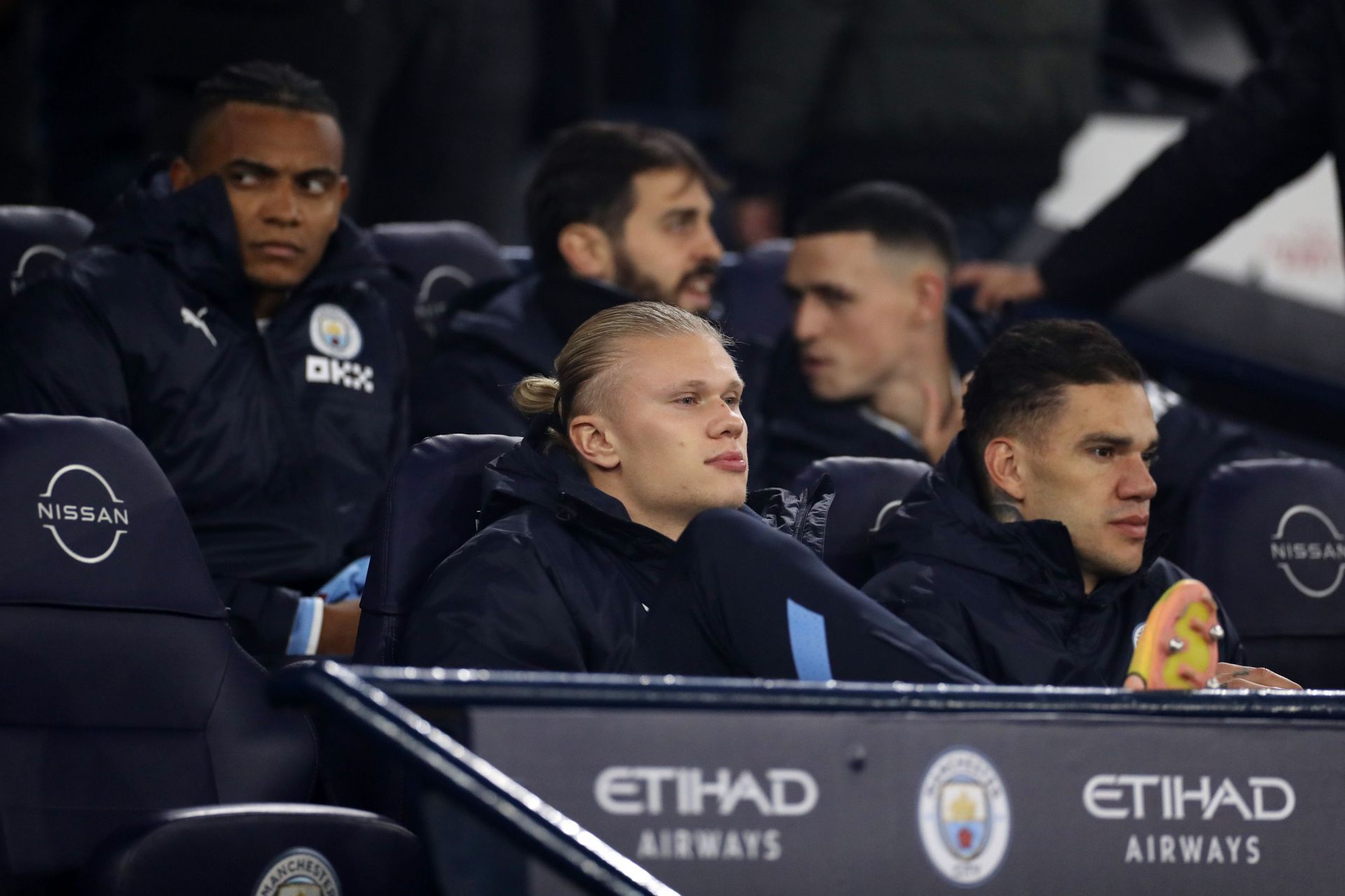 Erling Haaland, Ederson, Manuel Akanji, Bernardo Silva and Phil Foden seated on City's bench