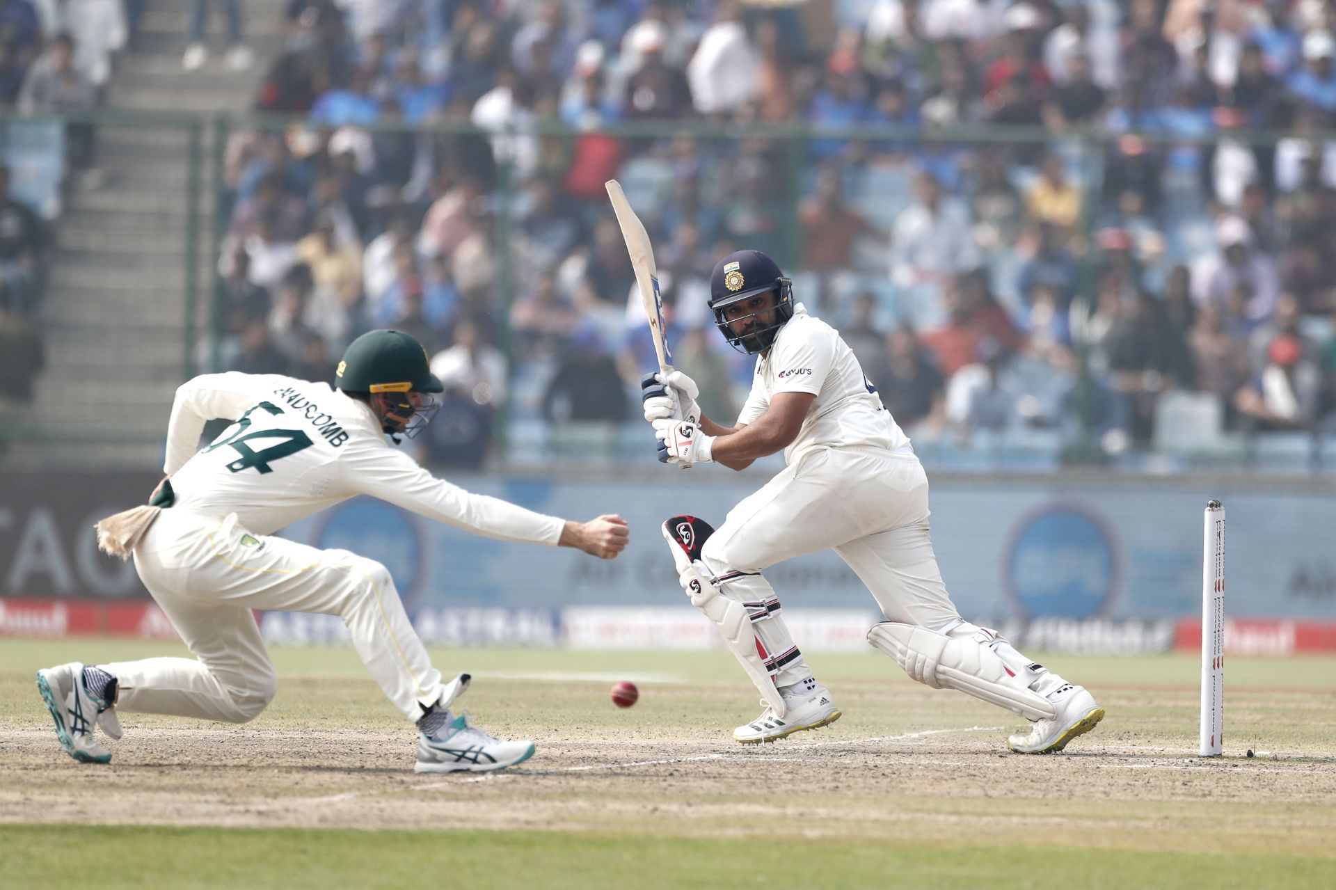 Rohit Sharma (right) whips the ball away on the leg side