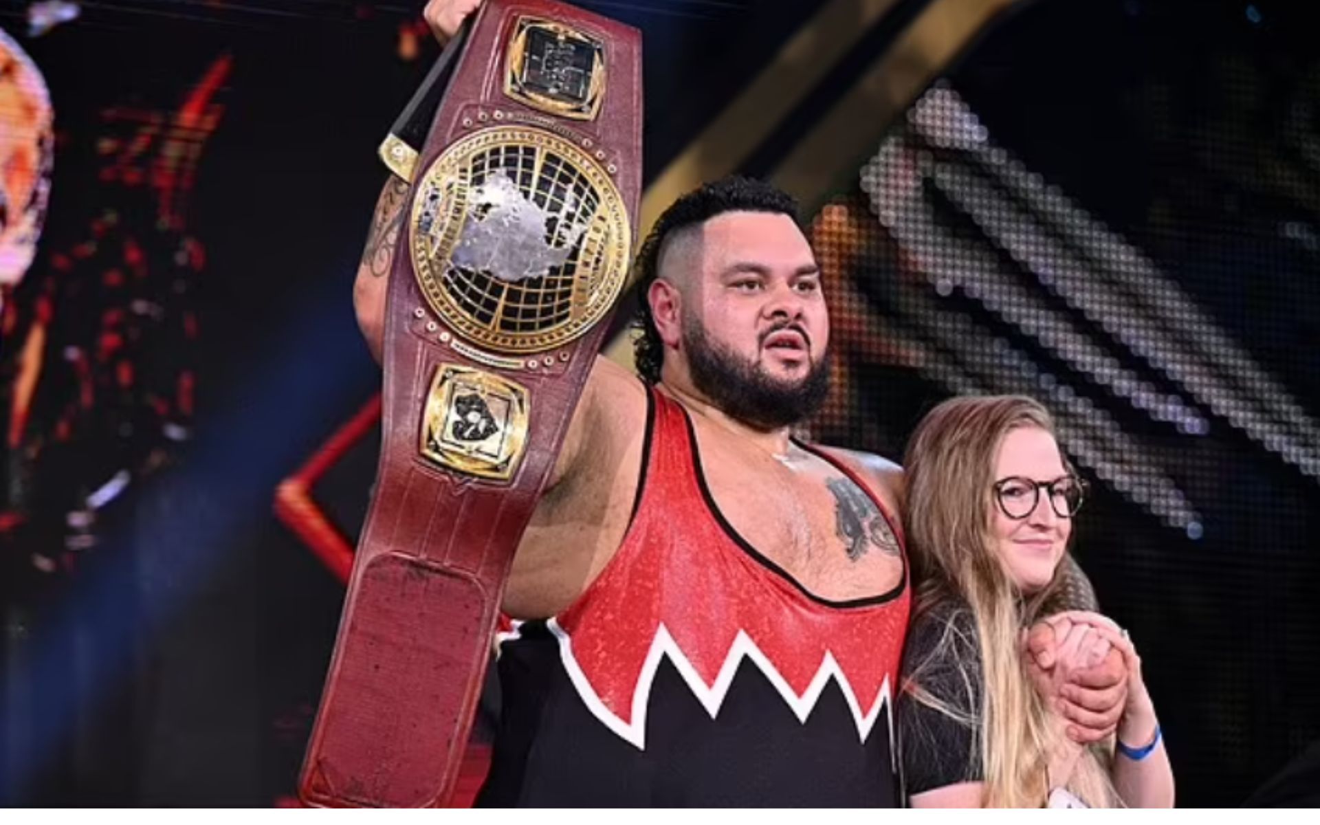 Bronson Reed and Paige celebrating his title win on NXT