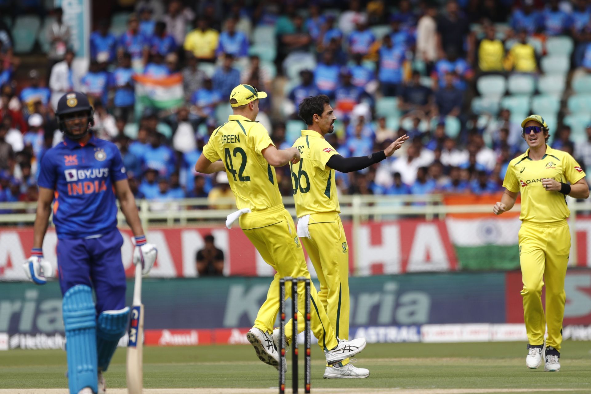 Shubman Gill (far left) walks off as Australian players celebrate