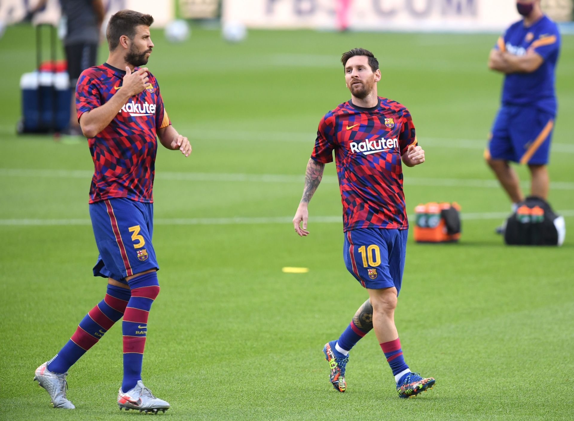 Pique (left) would like to see Messi back at the Nou Camp.
