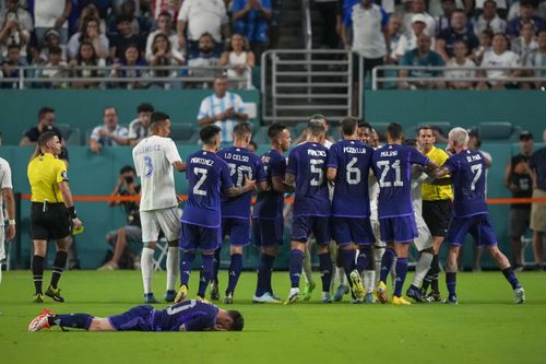 Messi's teammates rush to confront Honduras players.