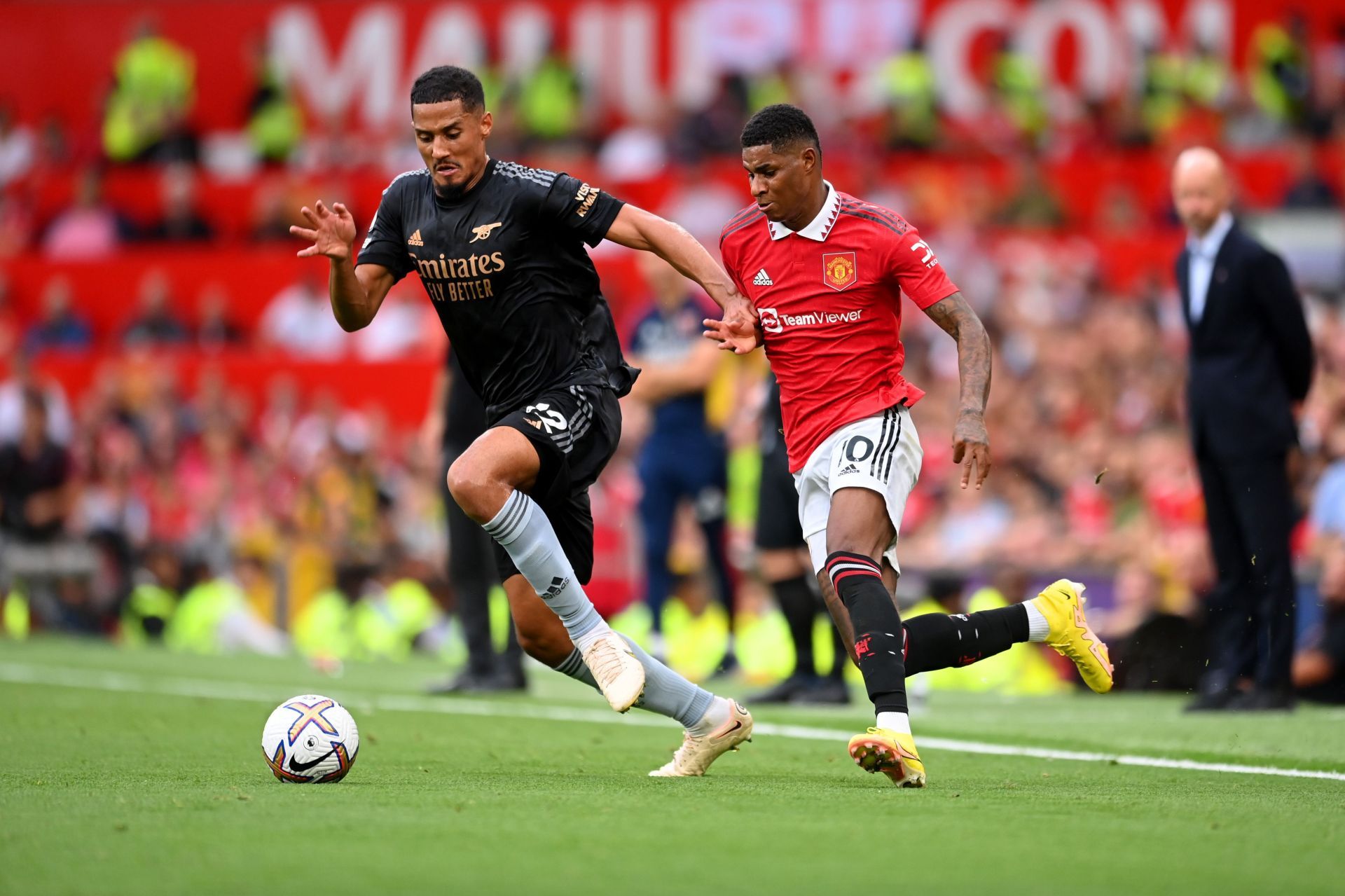 William Saliba is challenged by Marcus Rashford during Arsenal's Premier League clash with Manchester United.