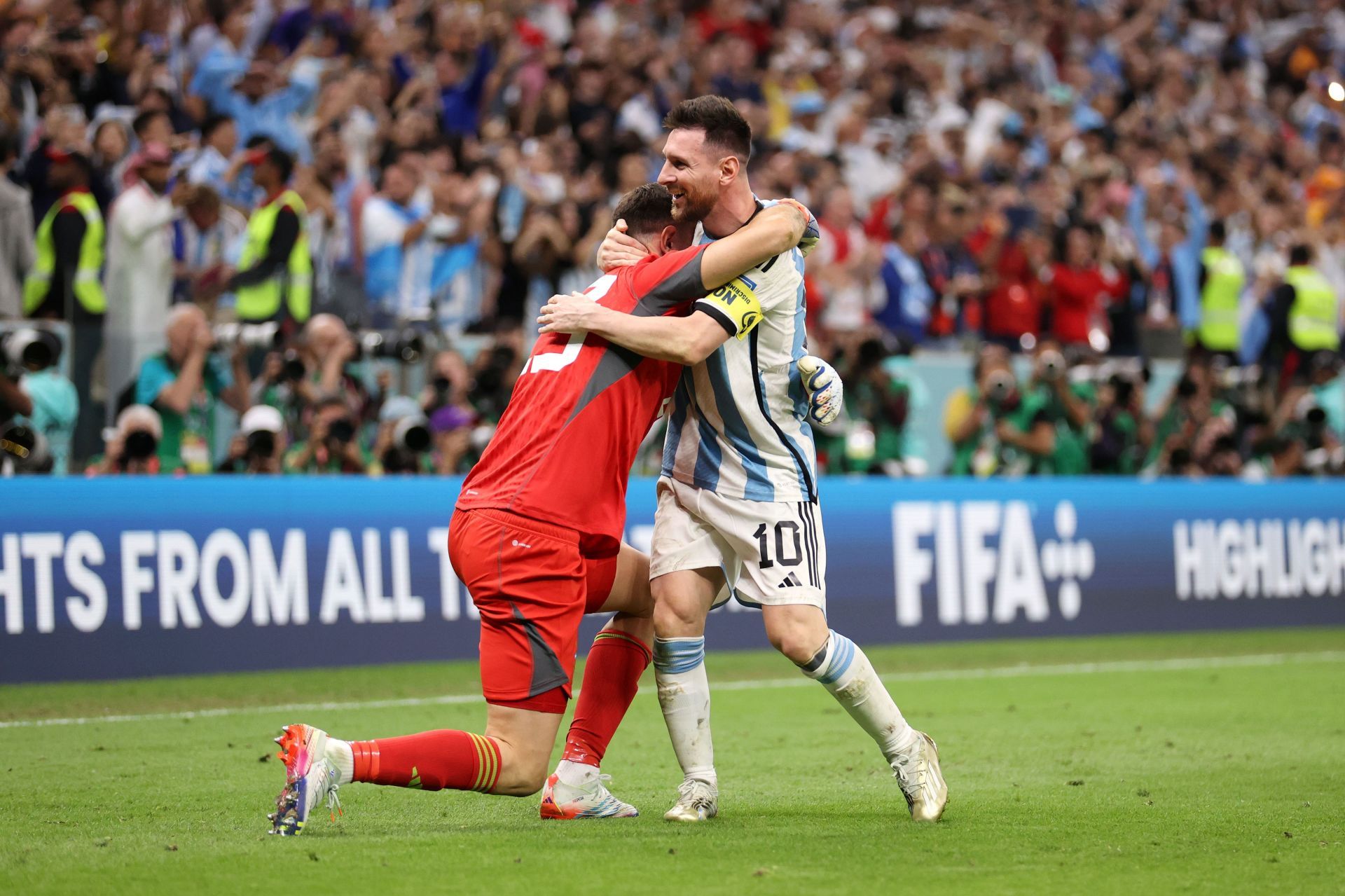 Messi hugs Martinez after he makes a crucial save during penalty shootouts against Netherlands