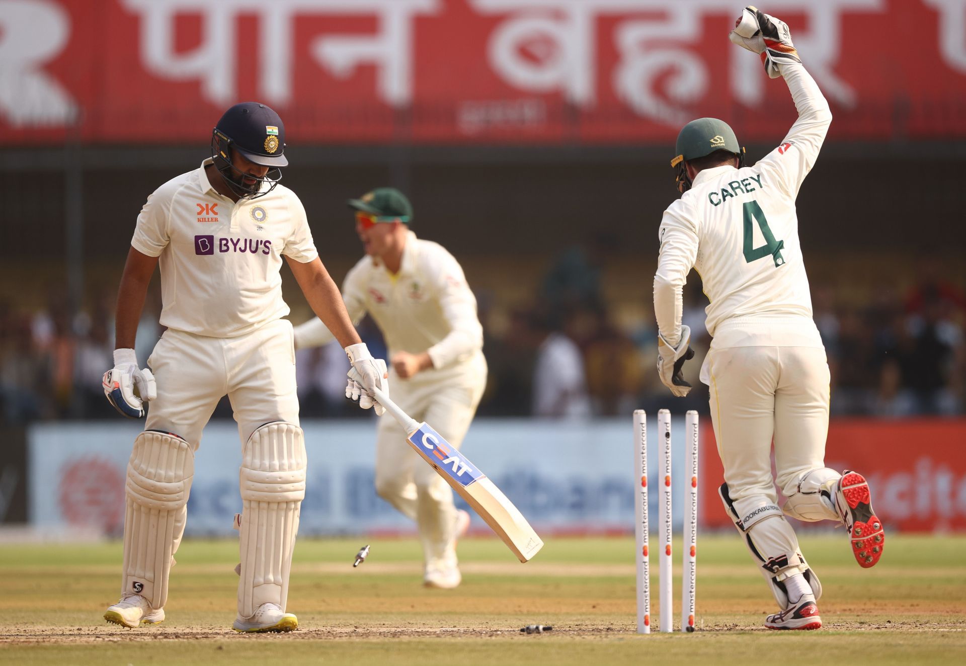 Alex Carey affects a stumping to dismiss Rohit Sharma. (Credits: Getty)