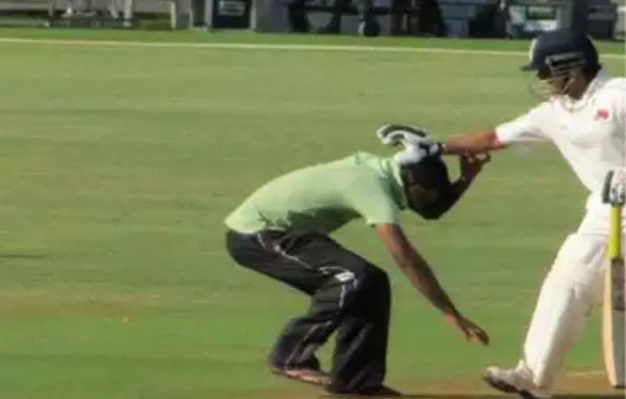 A fan touching Tendulkar’s feet during a Ranji game.