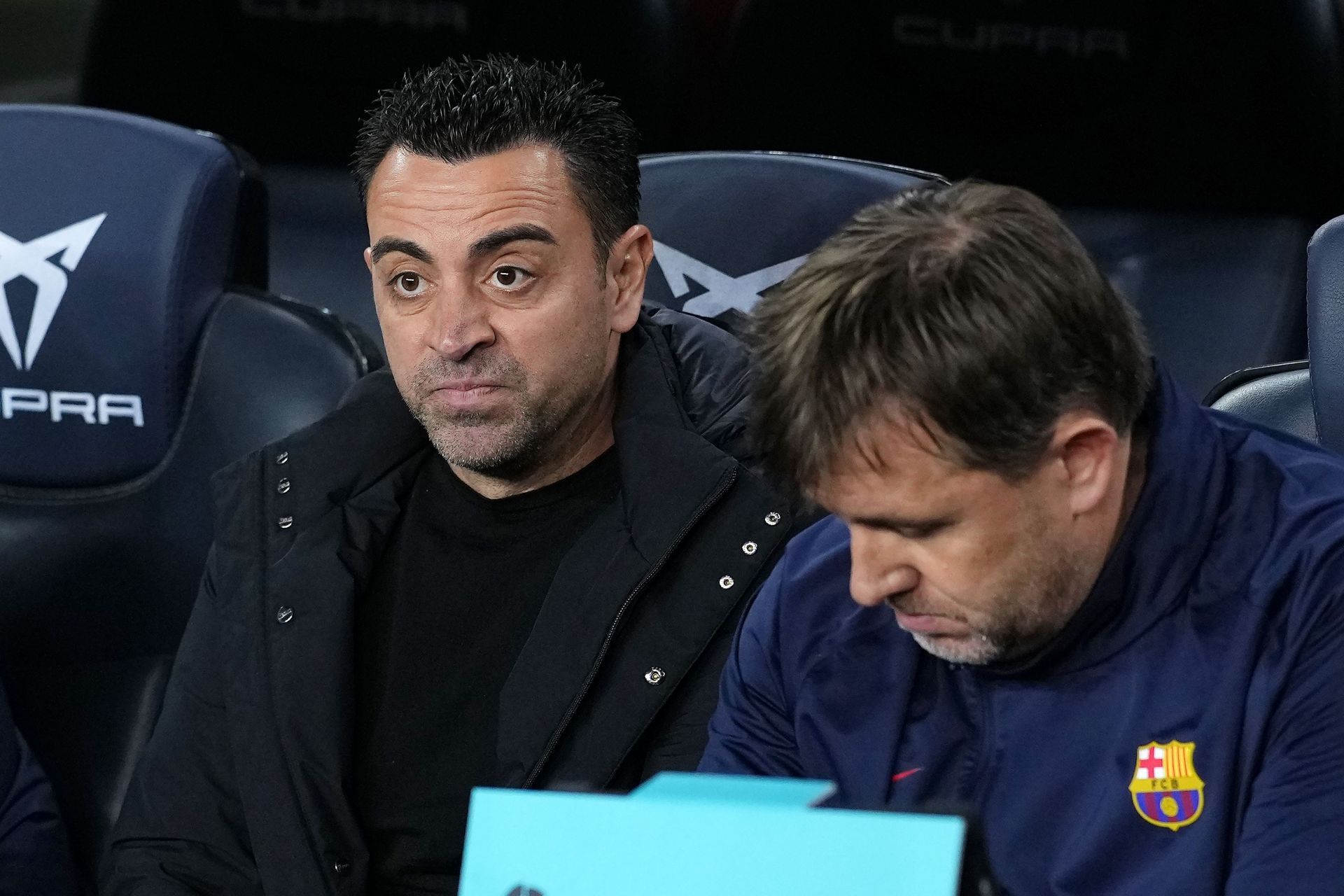 Barca boss Xavi (L).