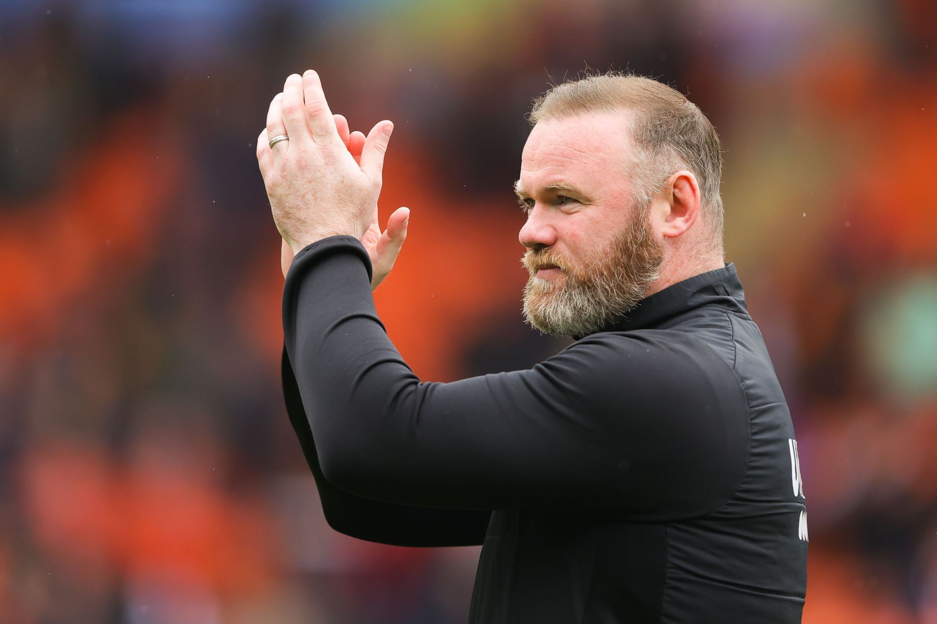 Wayne Rooney salutes three Red Devils.