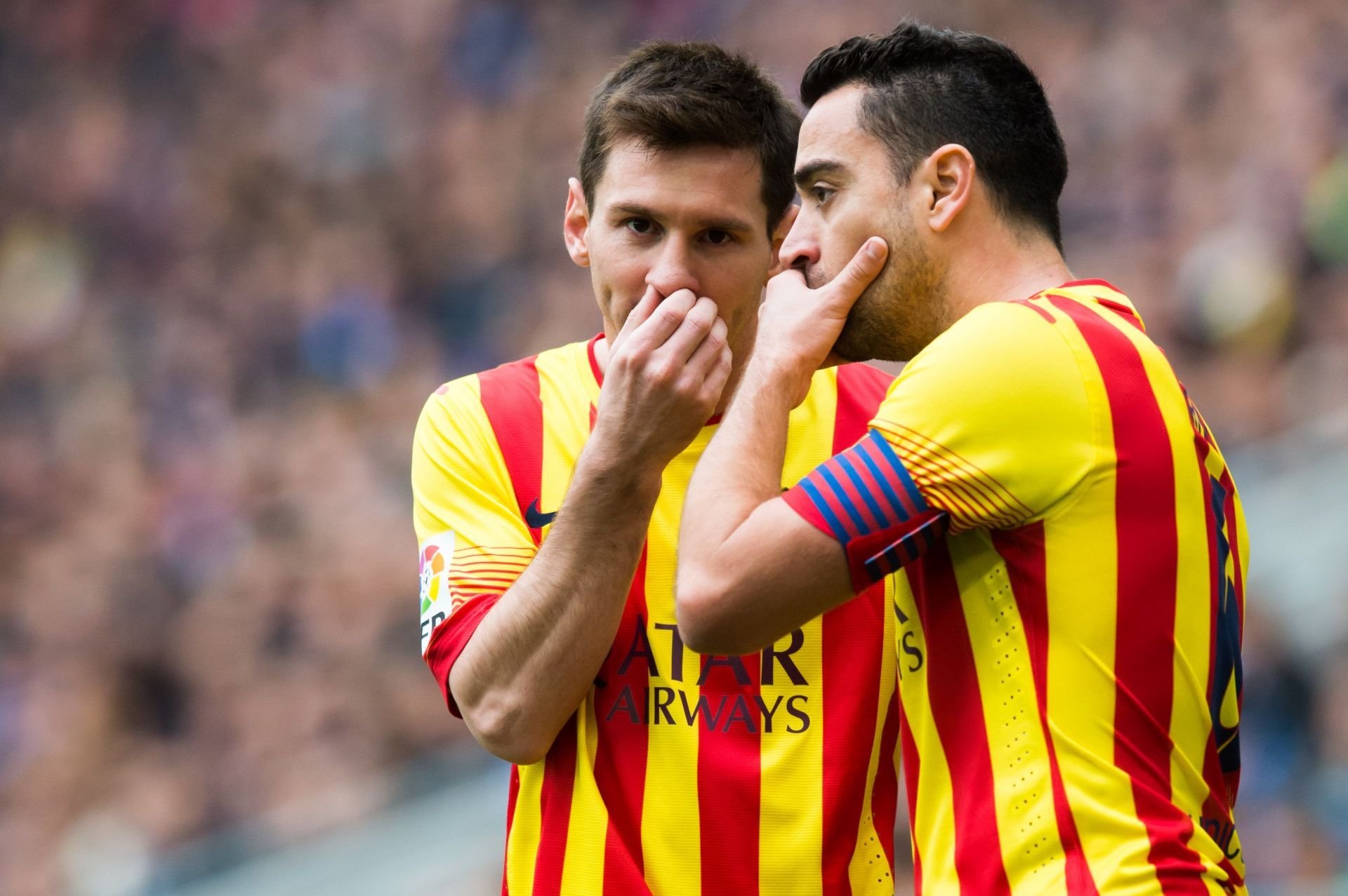 Messi (left) and Xavi were teammates at Barcelona.