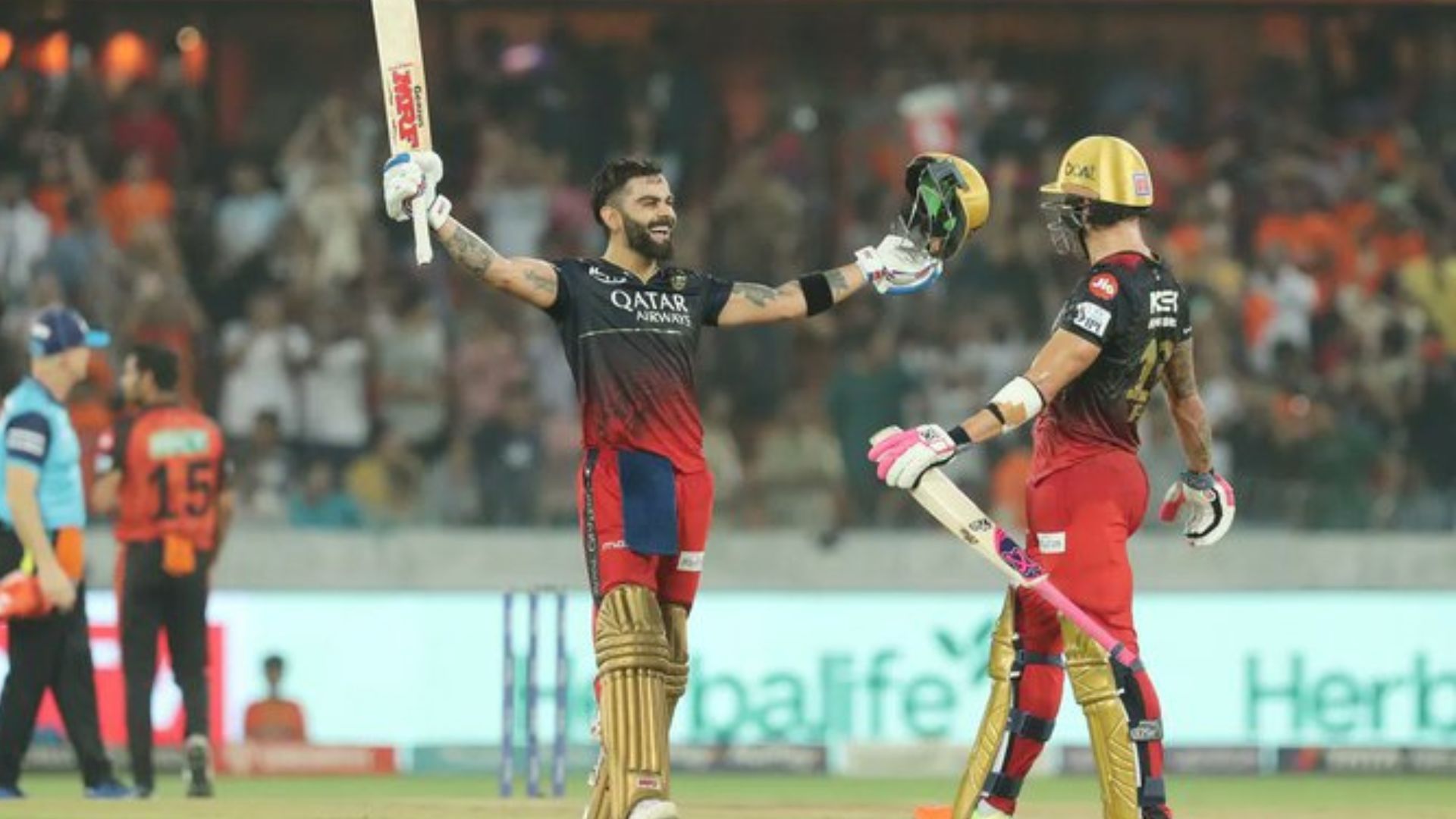 Virat Kohli raises his bat after scoring his 6th IPL century against the Sunrisers Hyderabad