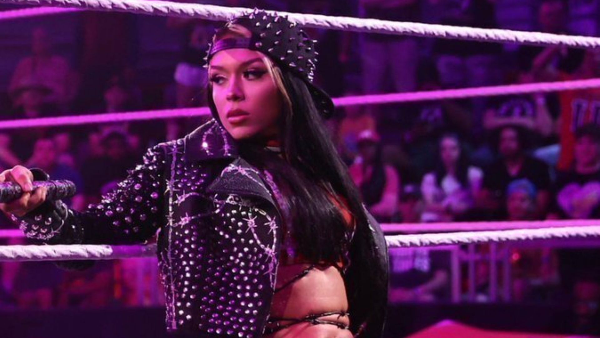 Cora Jade poses during her entrance on WWE NXT.