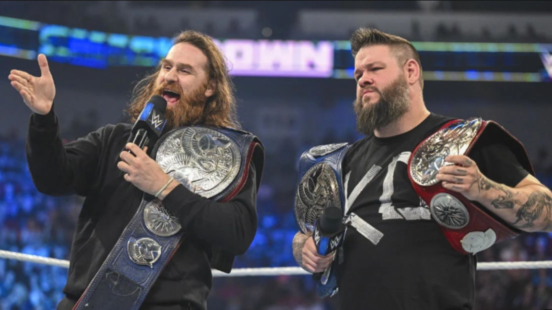 Sami Zayn and Kevin Owens with the Undisputed WWE Tag Team Championships.