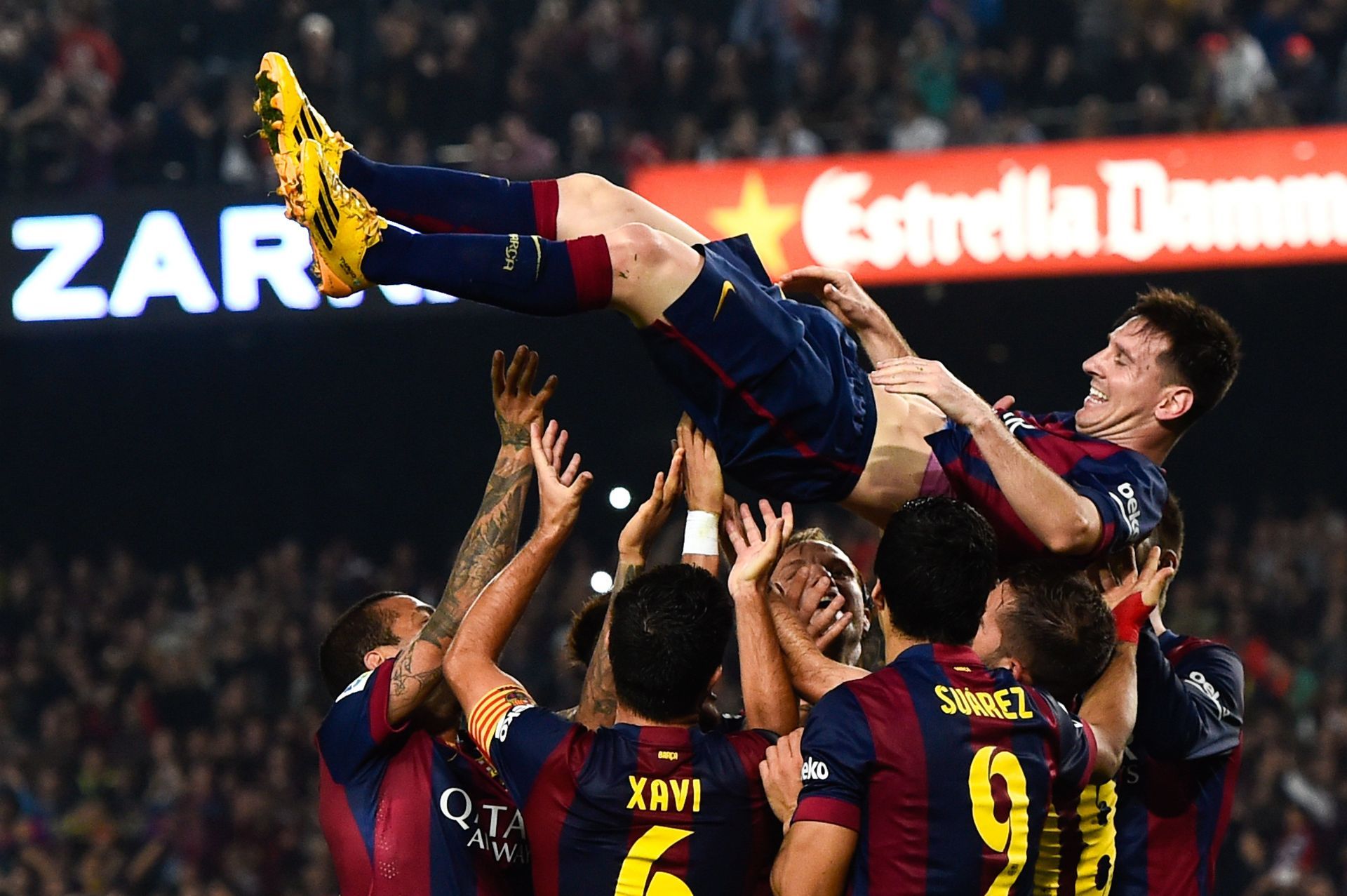 Lionel Messi, Barcelona's greatest player, being lifted by his teammates.