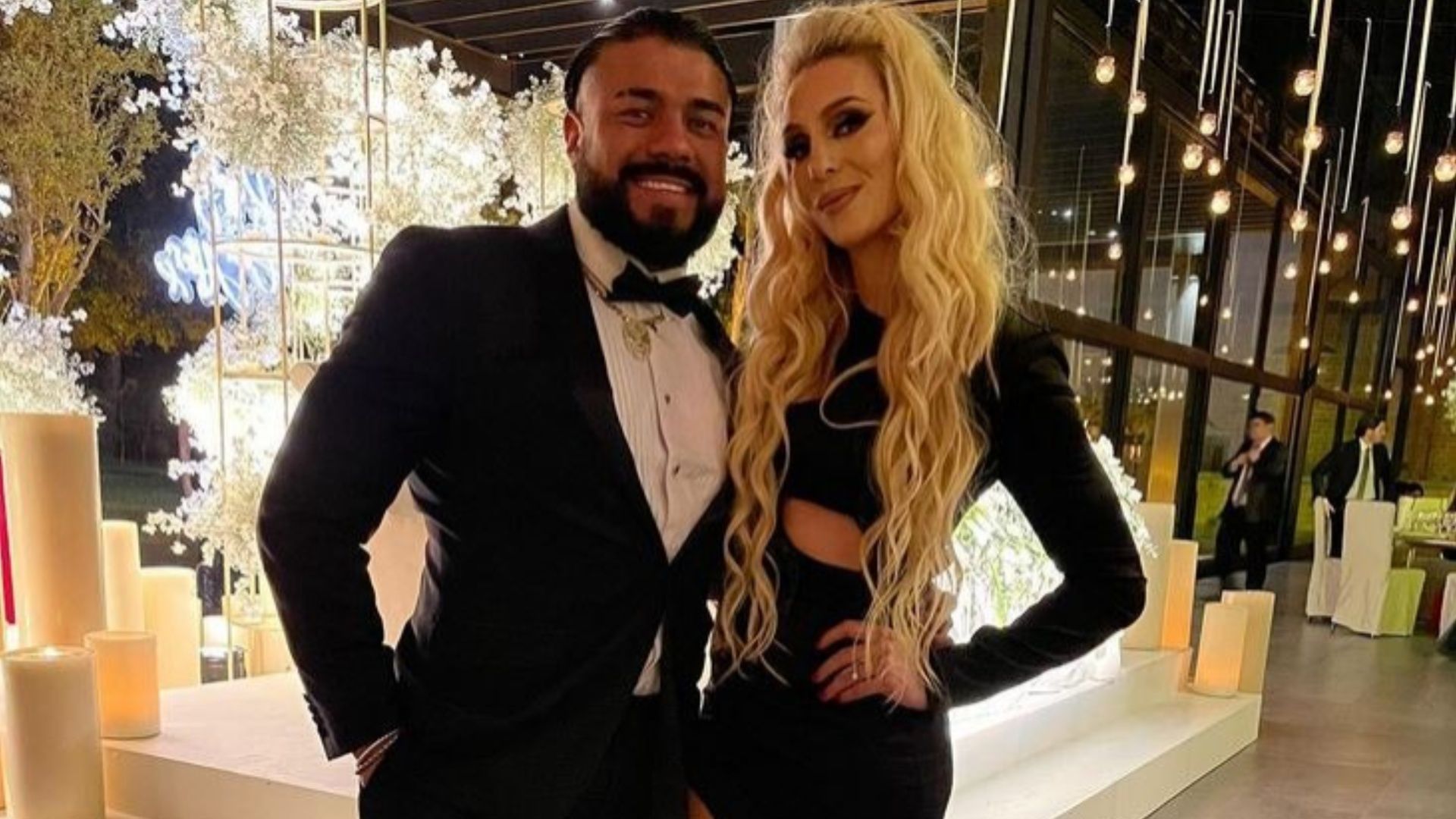 Andrade and Charlotte pose for a picture together.