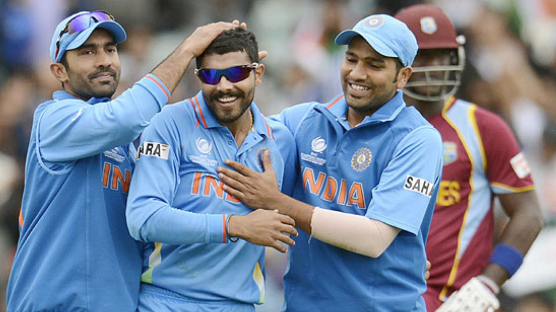Jadeja celebrates with his teammates after picking up a wicket against West Indies in CT 2013.