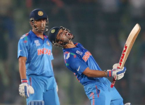 India v South Africa - ICC World Twenty20 Bangladesh 2014 - Kohli celebrates as Dhoni watches in the background