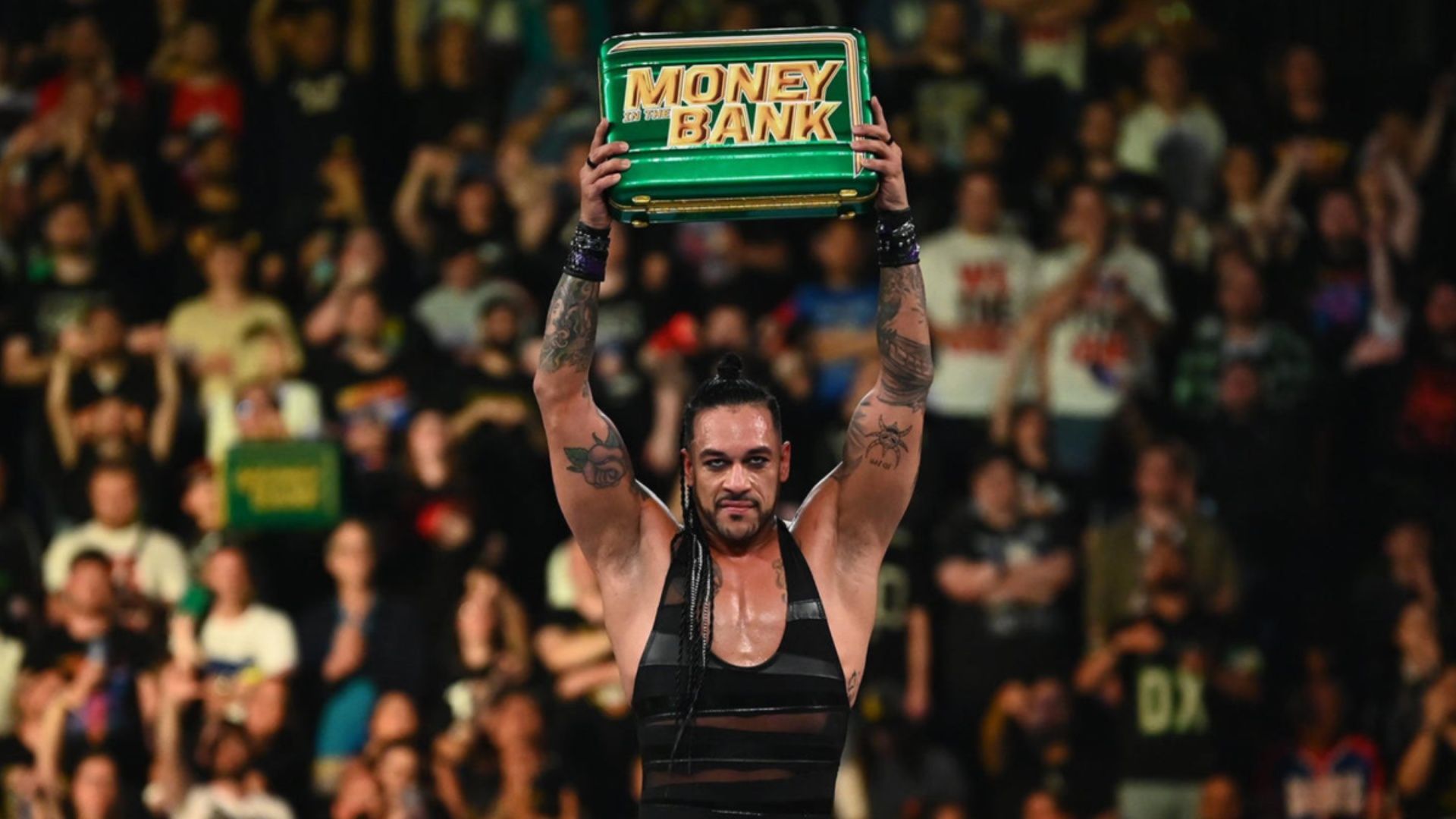 Damian Priest poses after winning Money in the Bank briefcase.