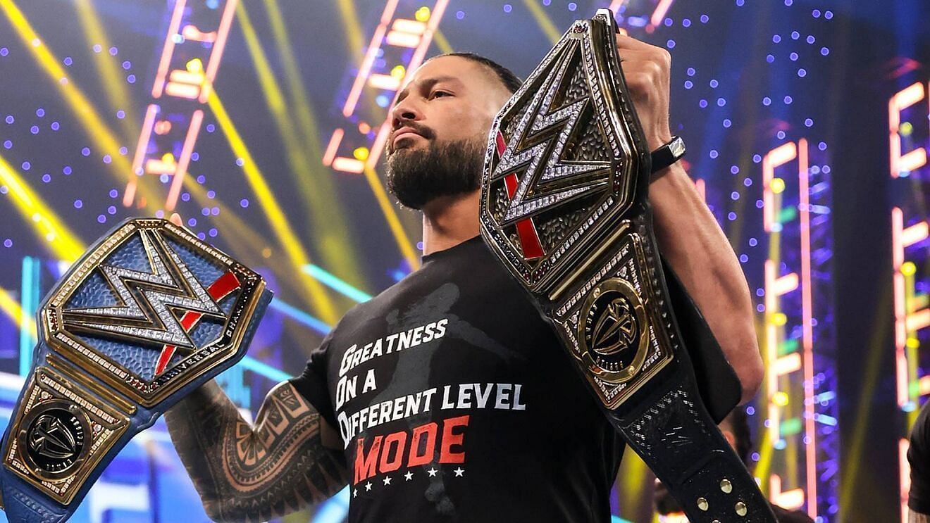 Roman Reigns lifting the WWE and Universal Championships
