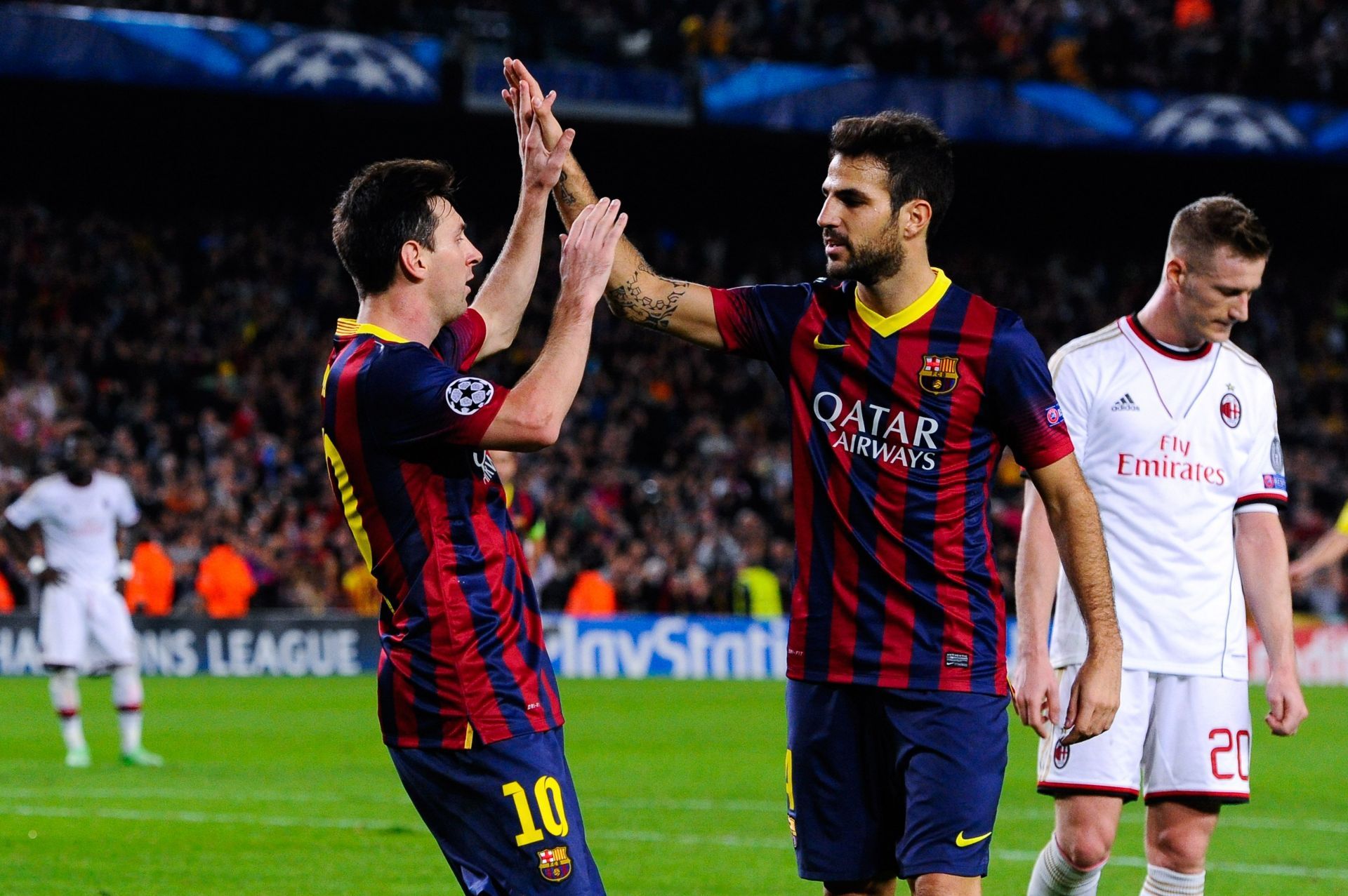 Lionel Messi and Cesc Fabregas (via Getty Images)