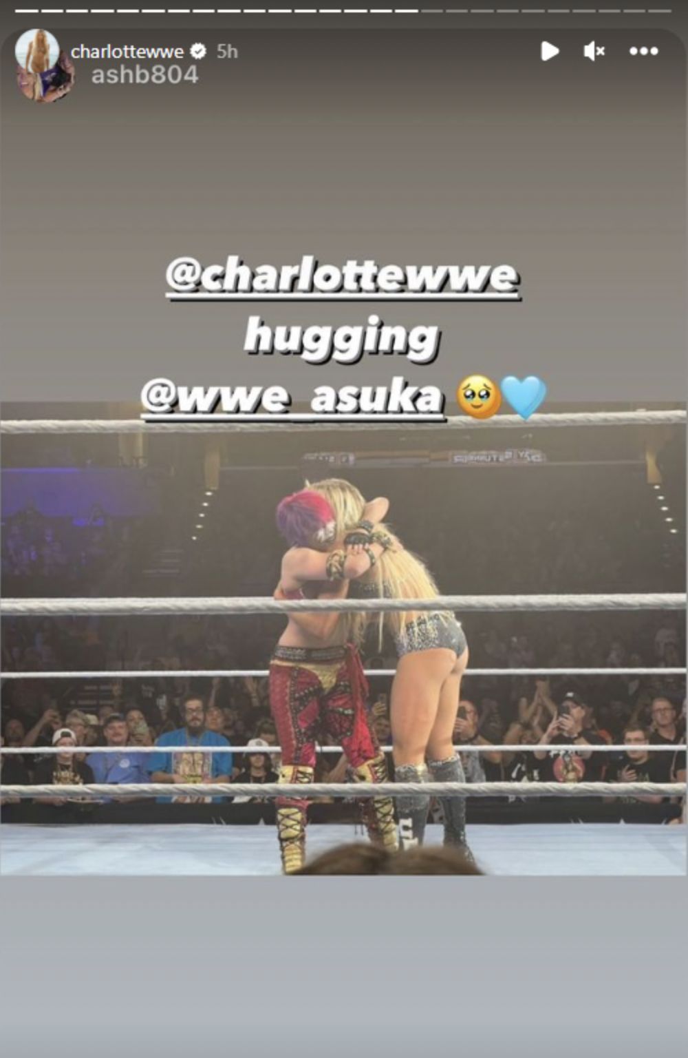 Asuka and Charlotte hugging