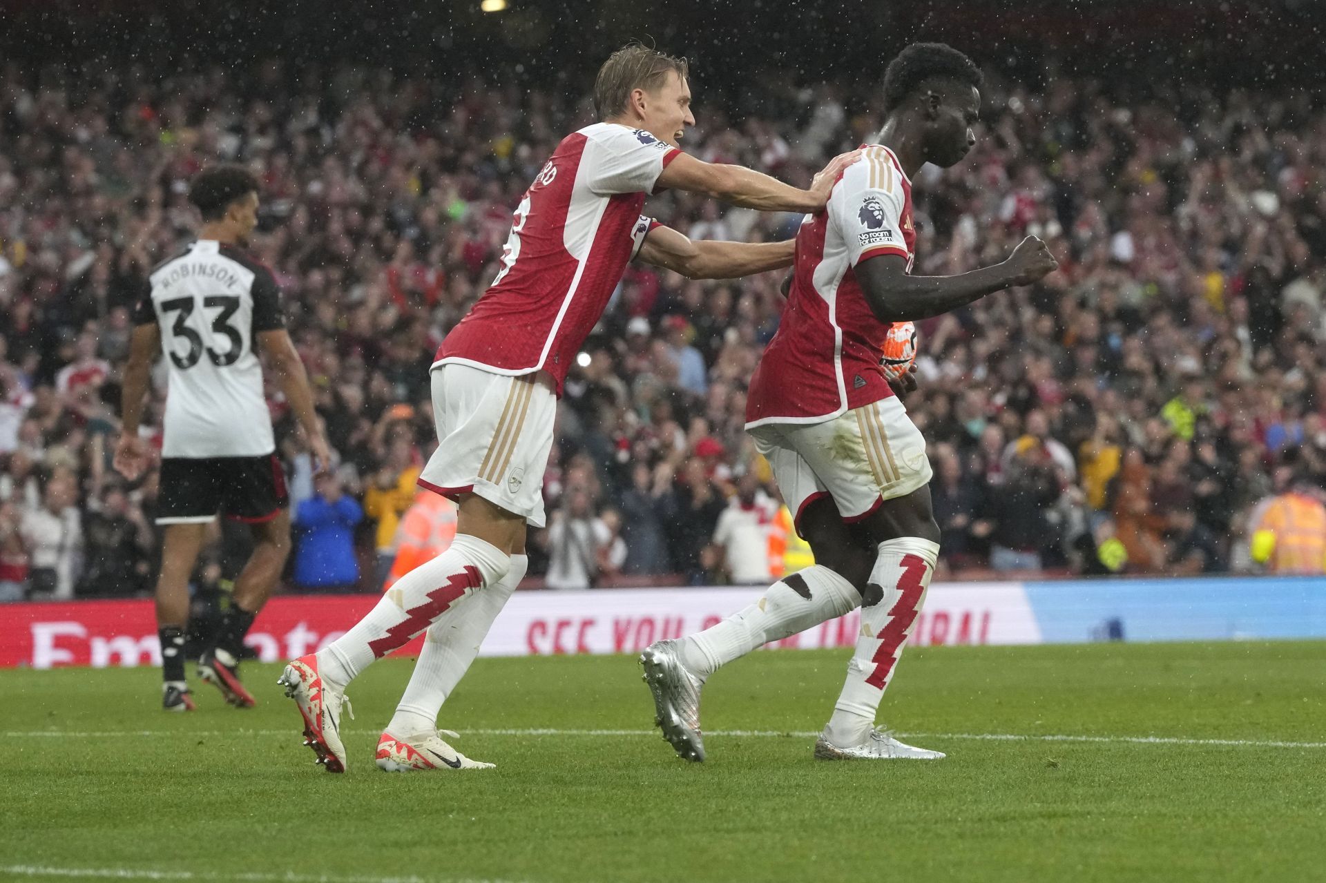 Bukayo Saka celebrates with Martin &Oslash;degaard