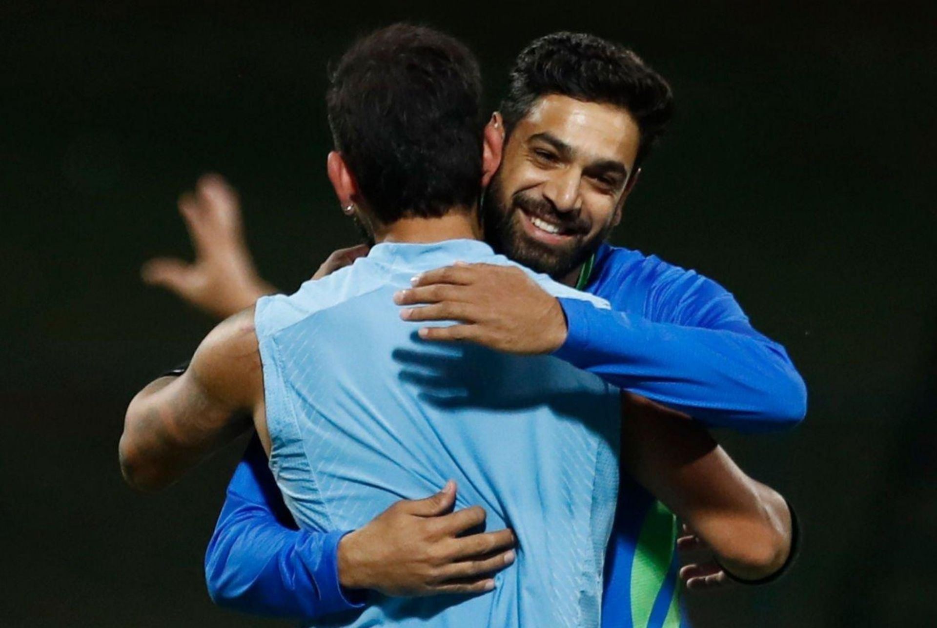 Haris Rauf and Virat Kohli greet each other during a practice session on Friday. 