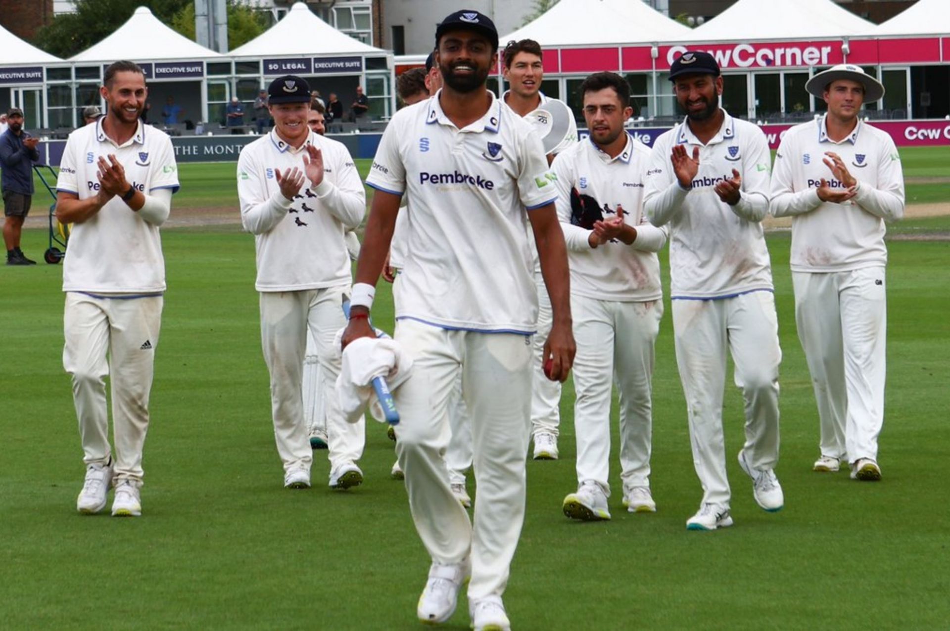 Jaydev Unadkat leading his team off the field. 