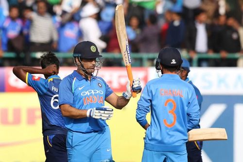 MS Dhoni raising his bat after a fifty in Dharamsala [Getty Images]