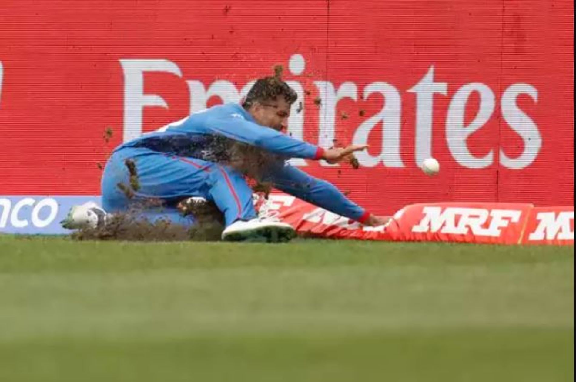 Mujeeb Ur Rahman dives on the outfield to prevent a boundary against Bangladesh