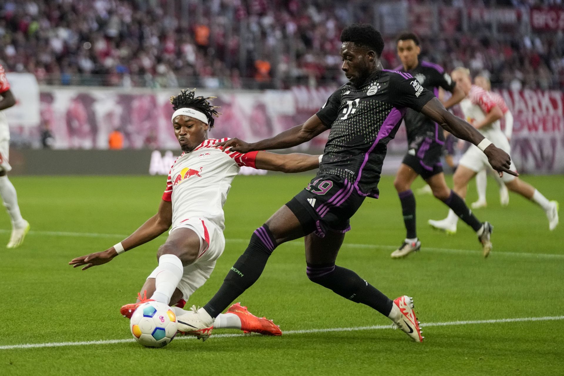 Alphonso Davies (right) is wanted at Stamford Bridge.