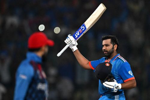 Rohit Sharma raising his bat after a century [Getty Images]