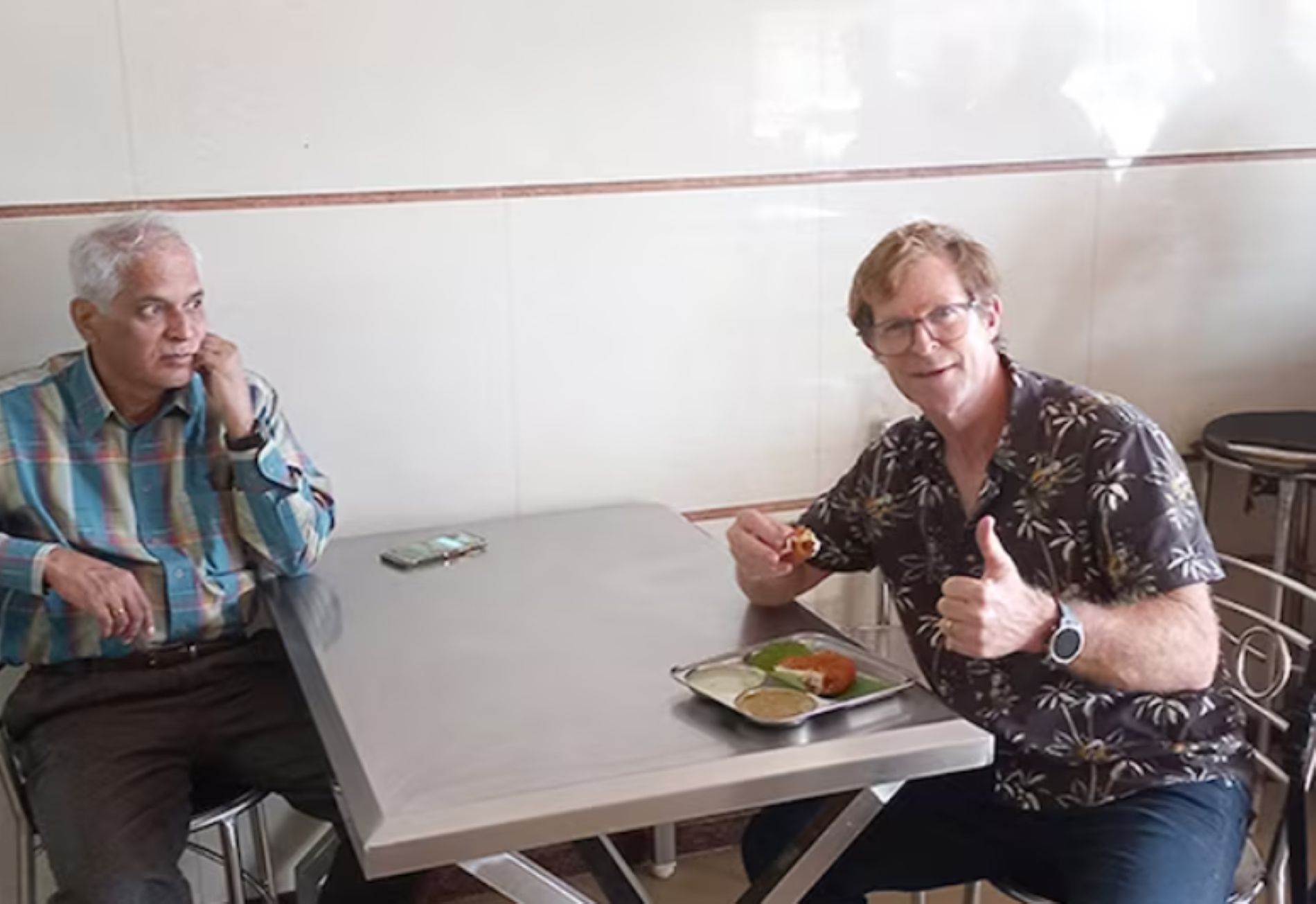 Rhodes enjoying a local dish at Bengaluru