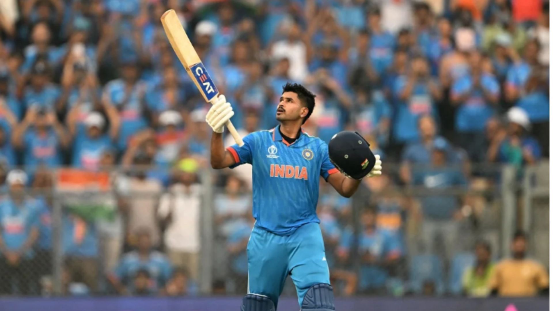 Shreyas Iyer raises his bat after completing his century against New Zealand in the semi-final. (Pic: Getty)