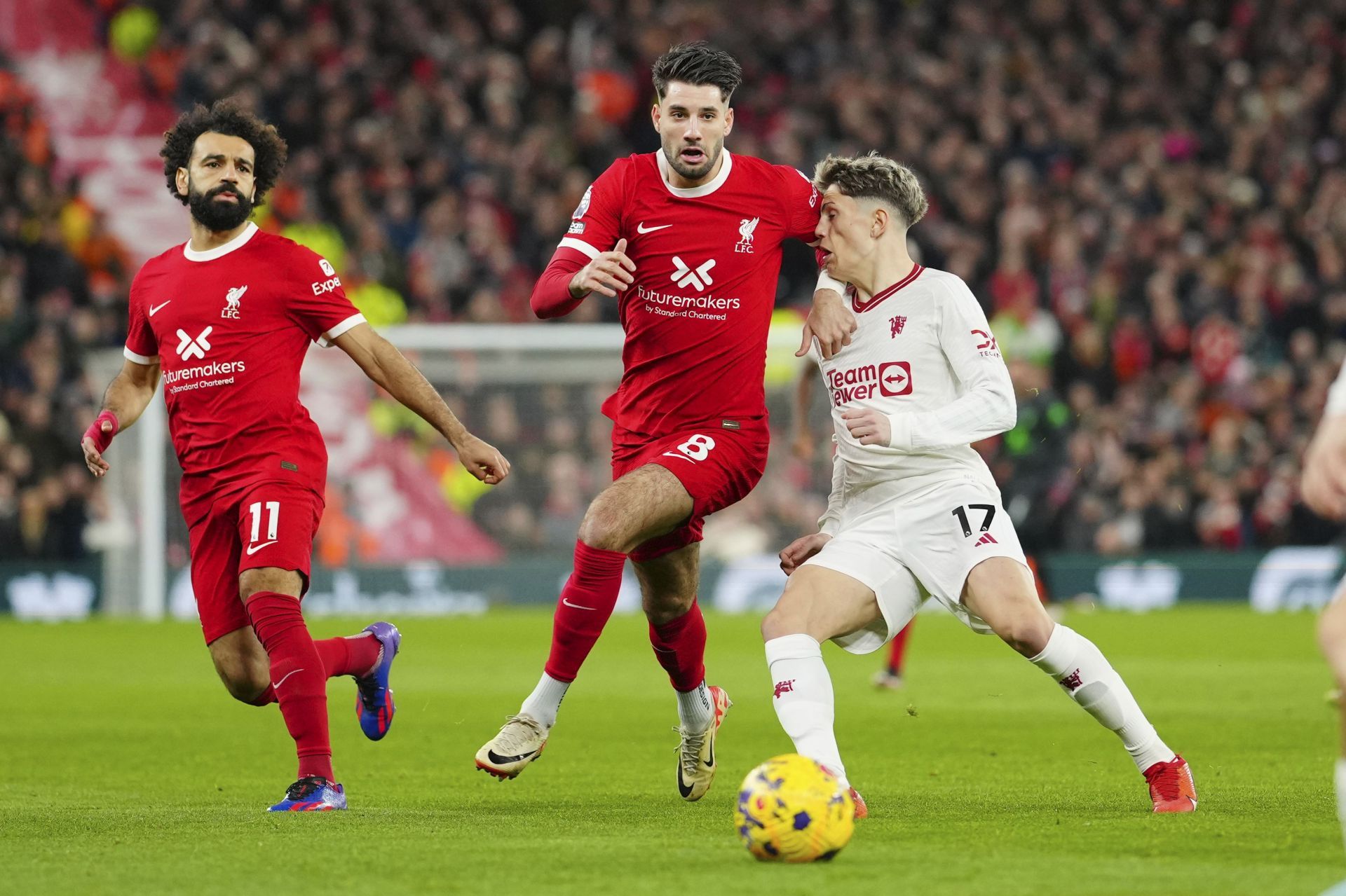 Manchester United's Alejandro Garnacho (right) fights for the ball with Liverpool's Dominik Szoboszlai (centre) and Mohamed Salah (left)