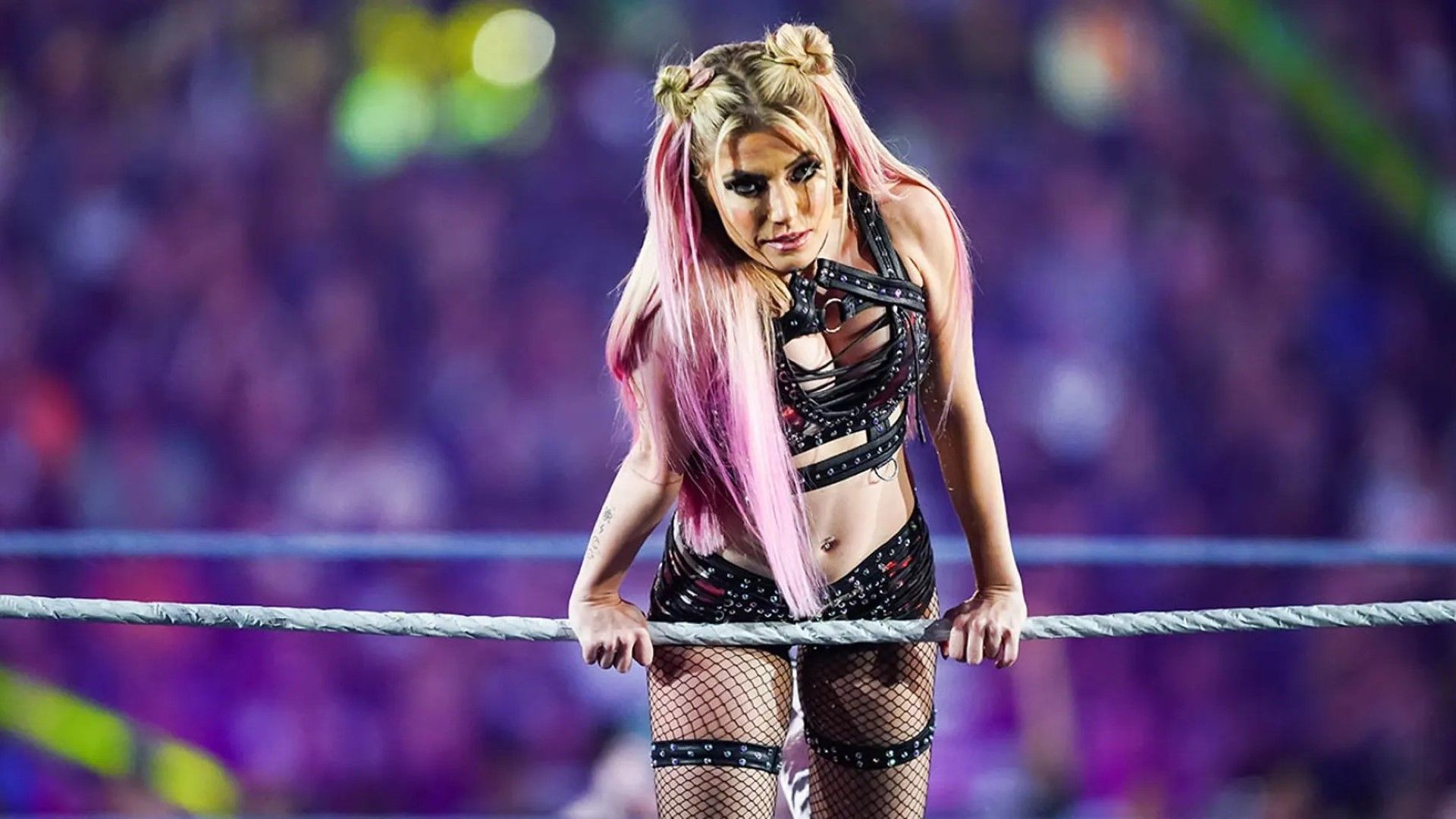 Alexa Bliss poses on the ropes in a WWE ring