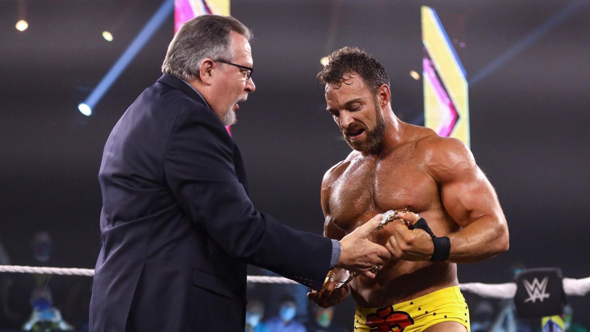 Ted DiBiase, Sr. presenting LA Knight with the Million Dollar Championship (Courtesy: WWE.com)