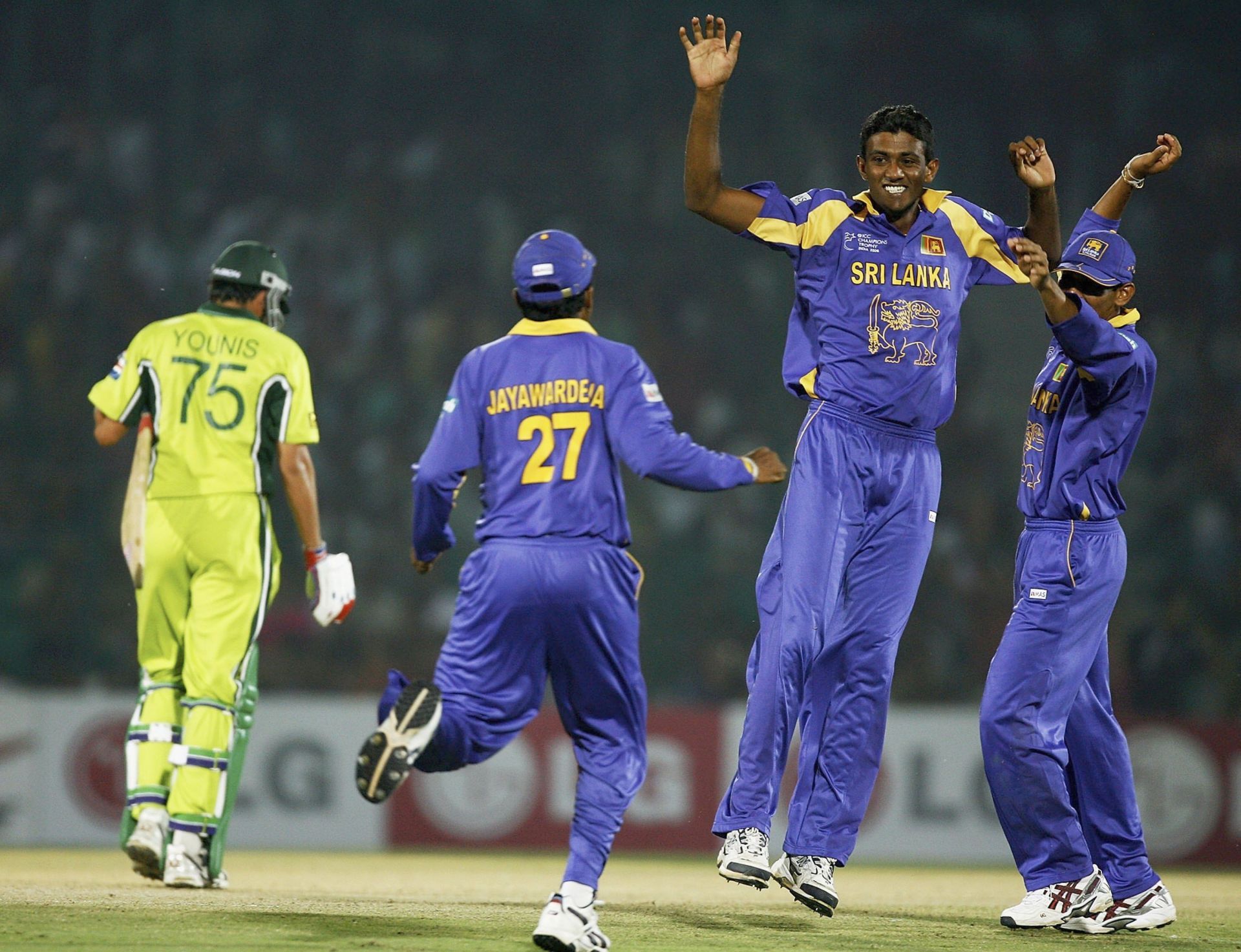 Farveez Maharoof (not wearing a cap) celebrates a wicket.