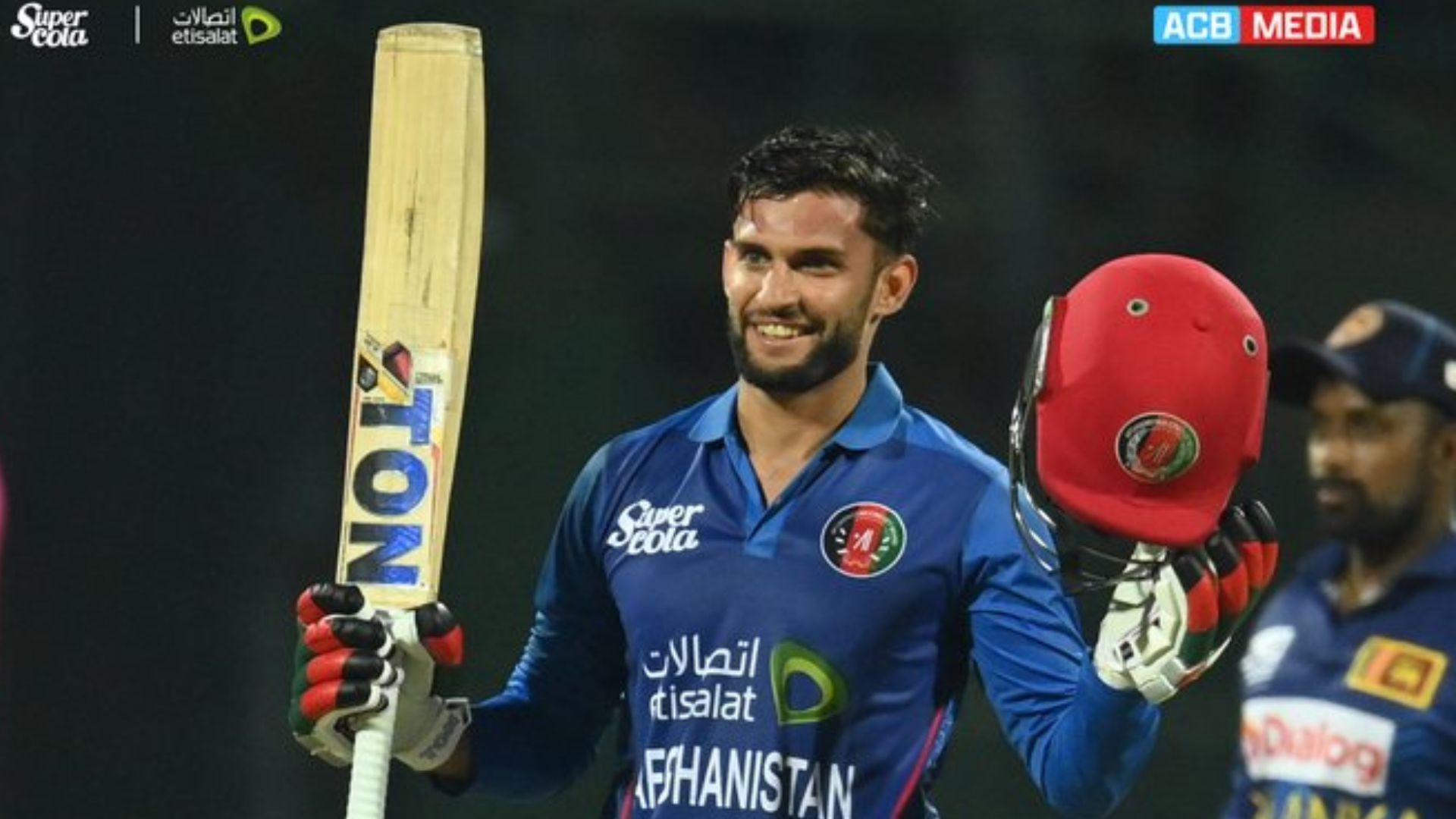 Azmatullah Omarzai raises his bat after completing his maiden ODI century. 