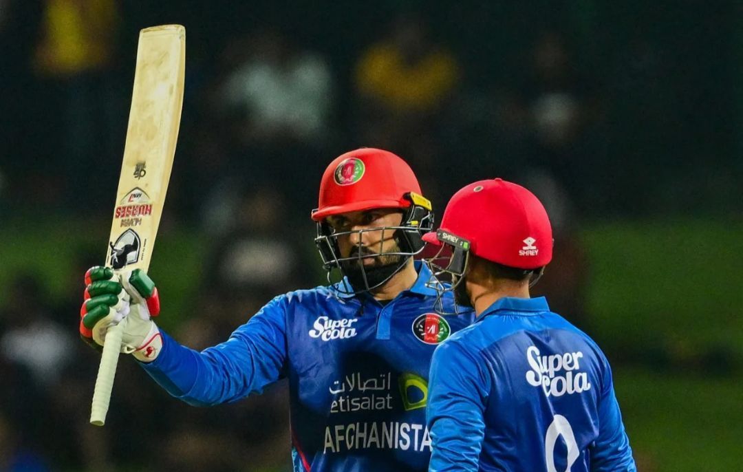 Mohammad Nabi raising his bat after his milestone vs SL