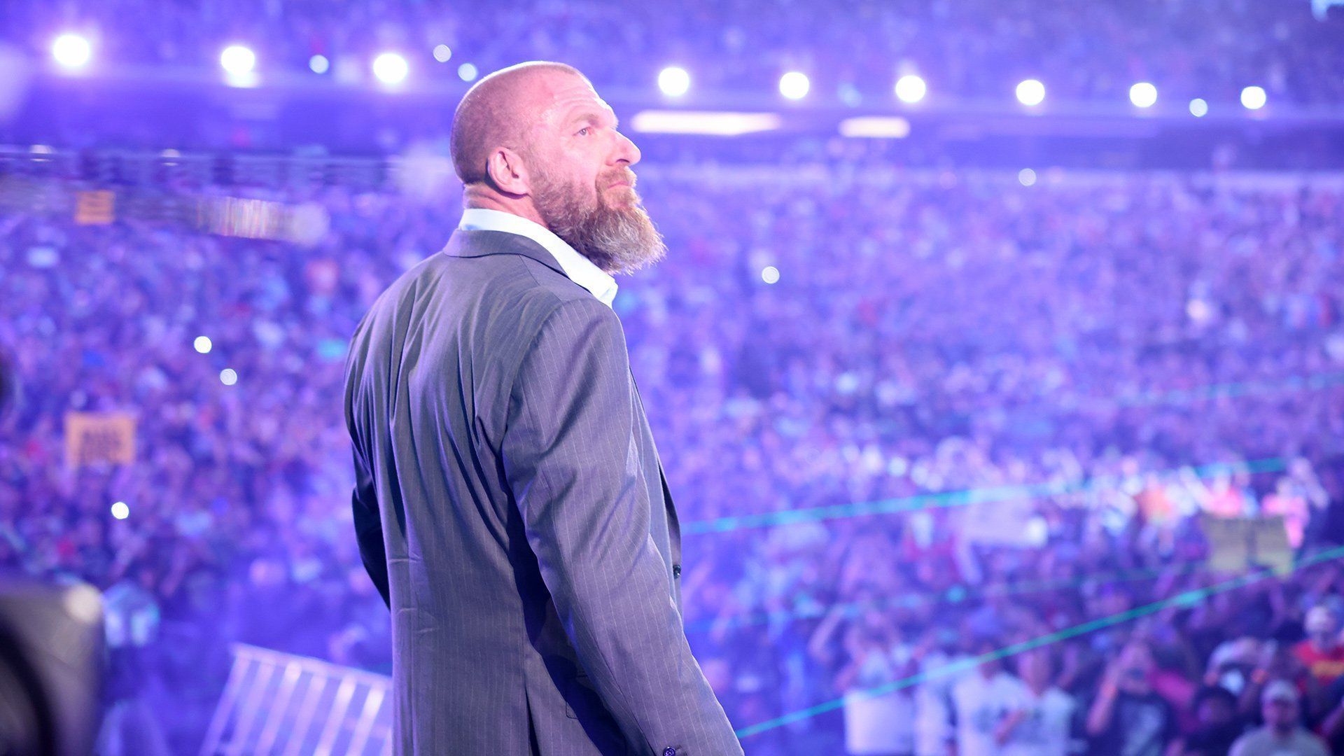 WWE Chief Content Officer Triple H looks out at a packed crowd