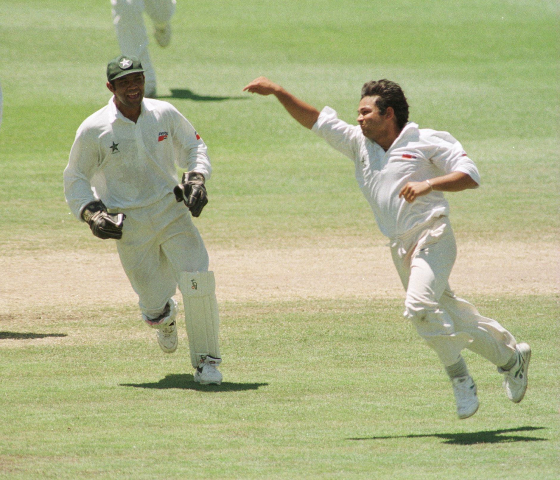 Pakistan's former leggie Mushtaq Ahmed celebrating with wicketkeeper Rashid Latif.