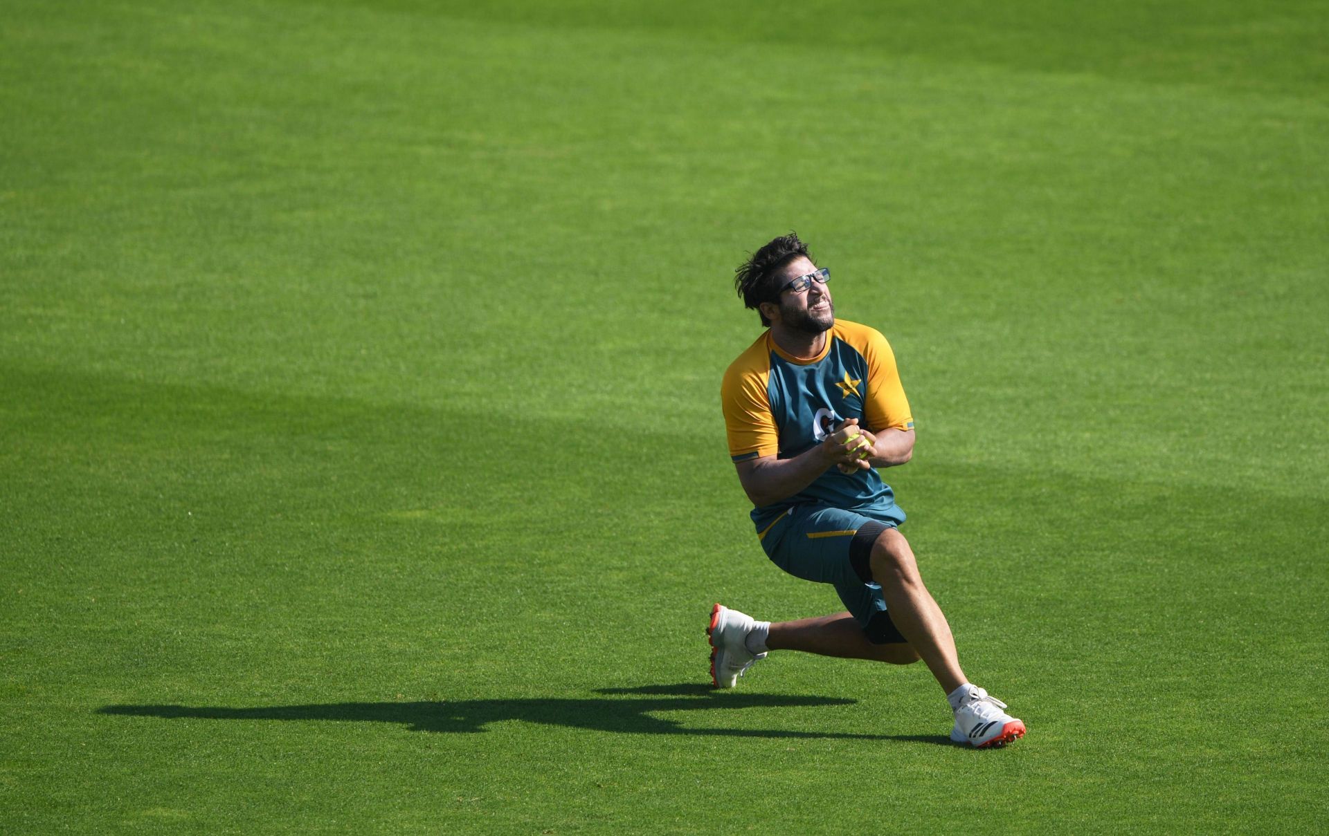Imam attempts a sliding catch during warm-up.