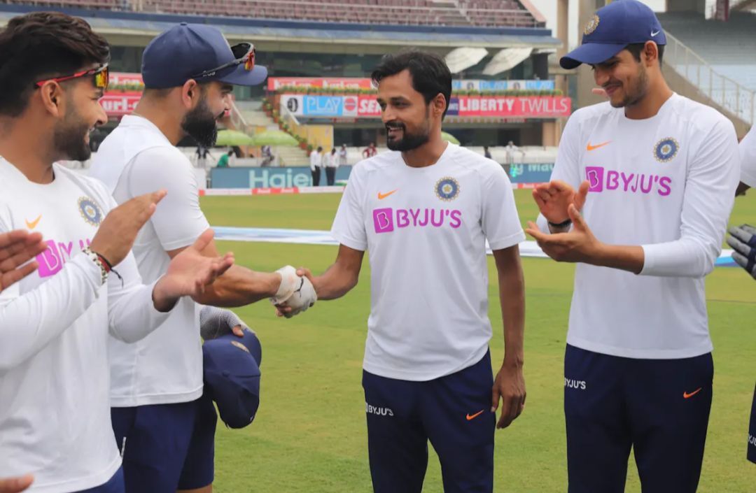 Virat Kohli handing the Test cap to Shahbaz Nadeem 