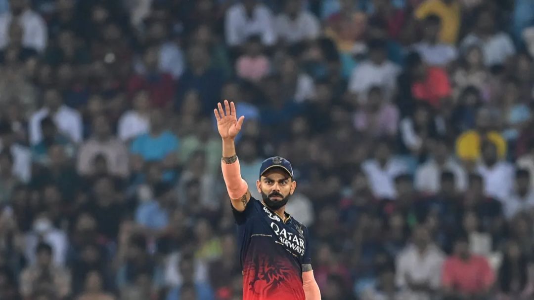 Virat Kohli waving his hand while fielding