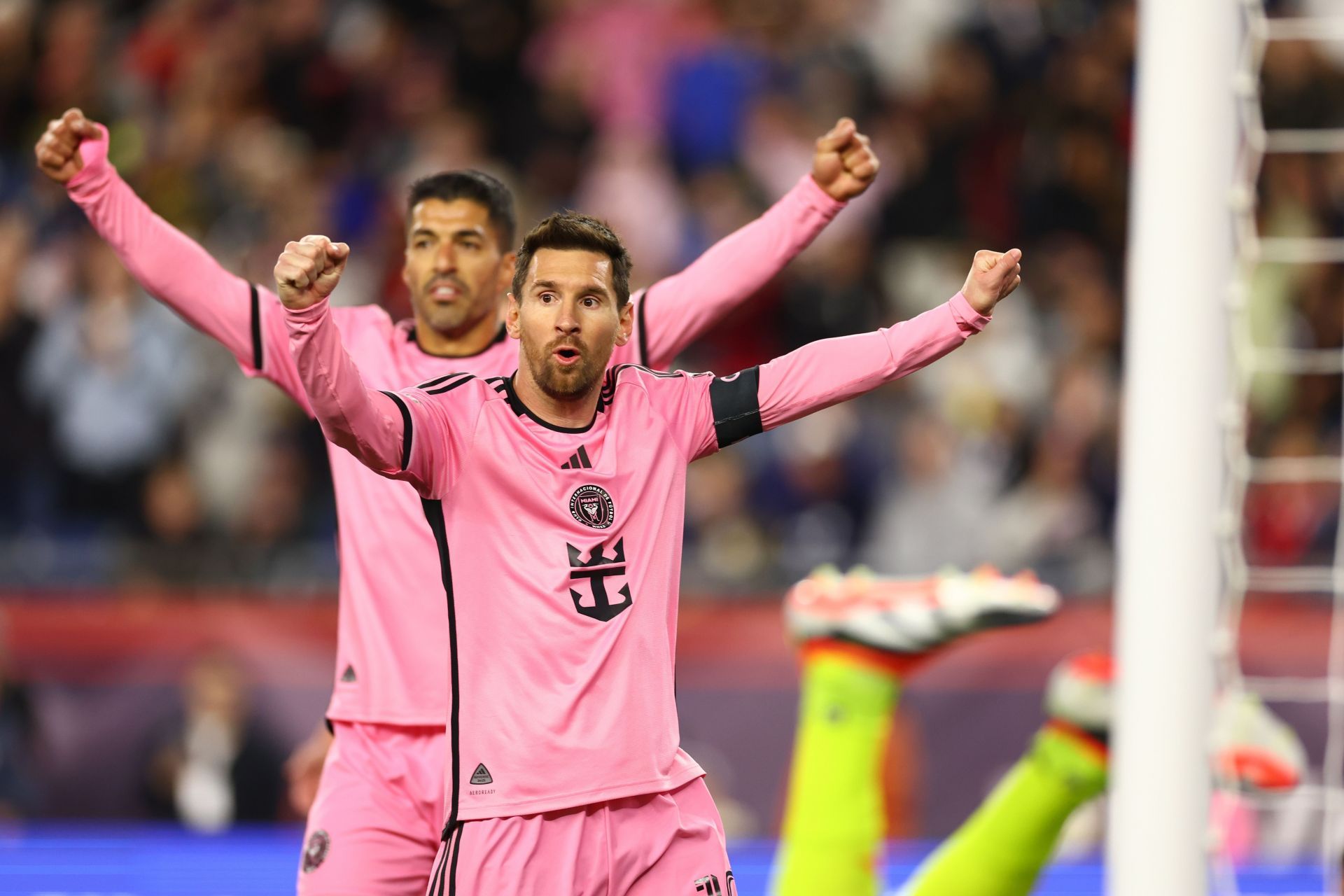 Lionel Messi and Luis Suarez (behind)