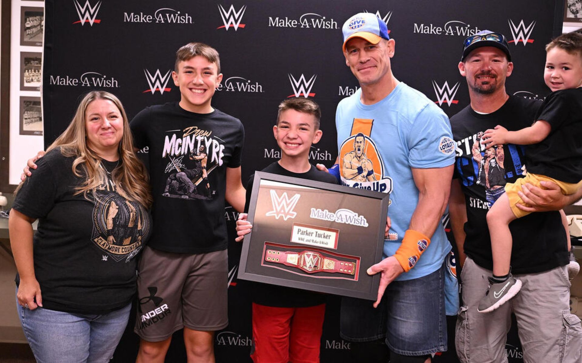 John Cena grants a child's wish through the Make-A-Wish Foundation.