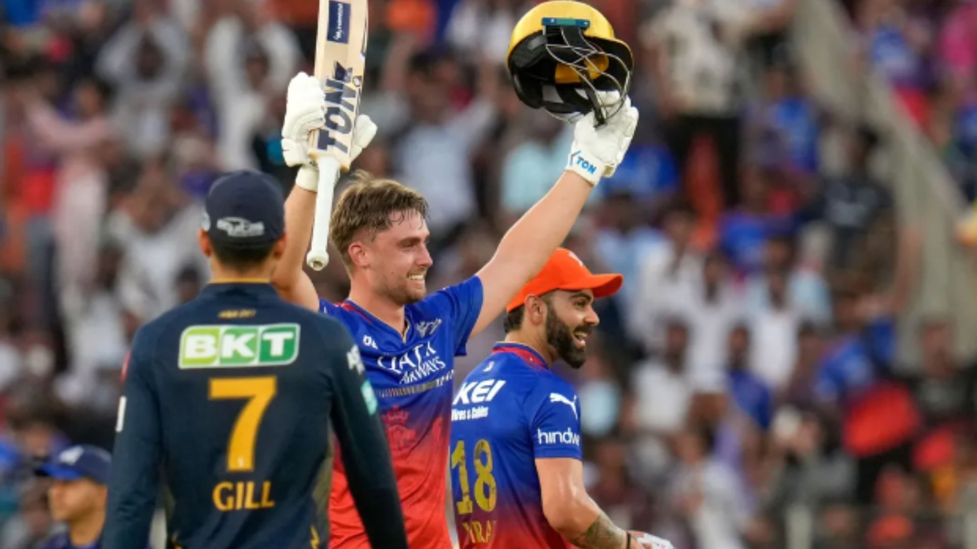 Jacks raises his bat after completing his century against the Titans.