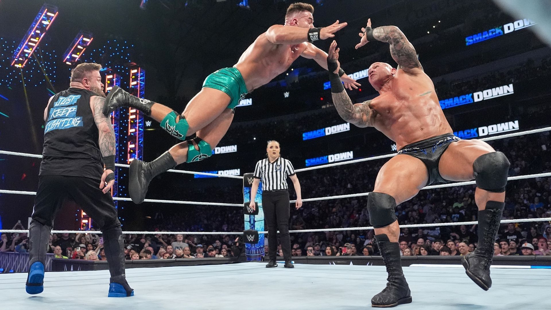 Kevin Owens and Randy Orton destroying Austin Theory [Image via WWE.com]