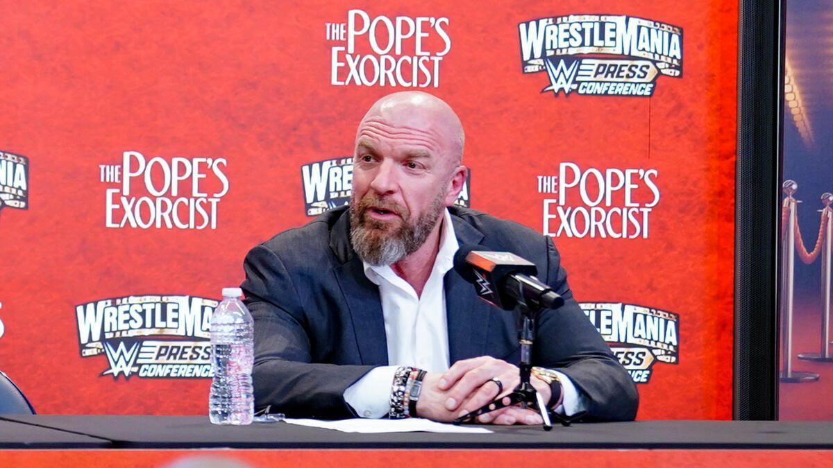 Triple H addressing the media during one of WWE